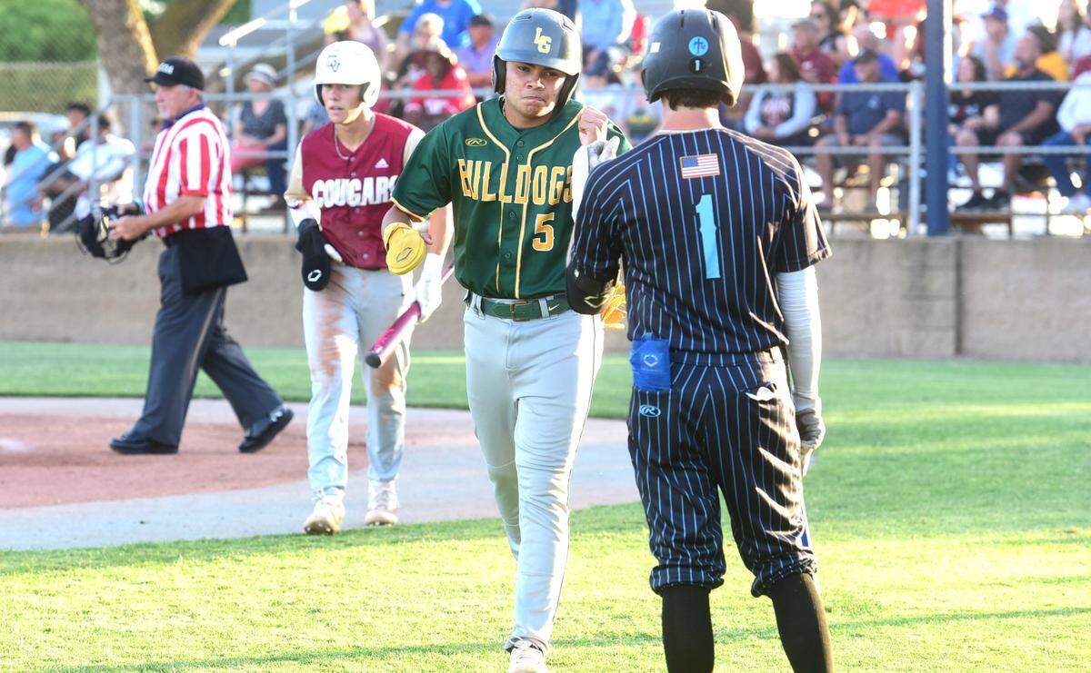 Le Grand High’s Diego Martinez (left) is congratulated by El Capitan High’s Camden Peterson after Martinez scored a run during the first inning of the Merced County All-Star Baseball Game at Merced College on Saturday, June 8, 2024.