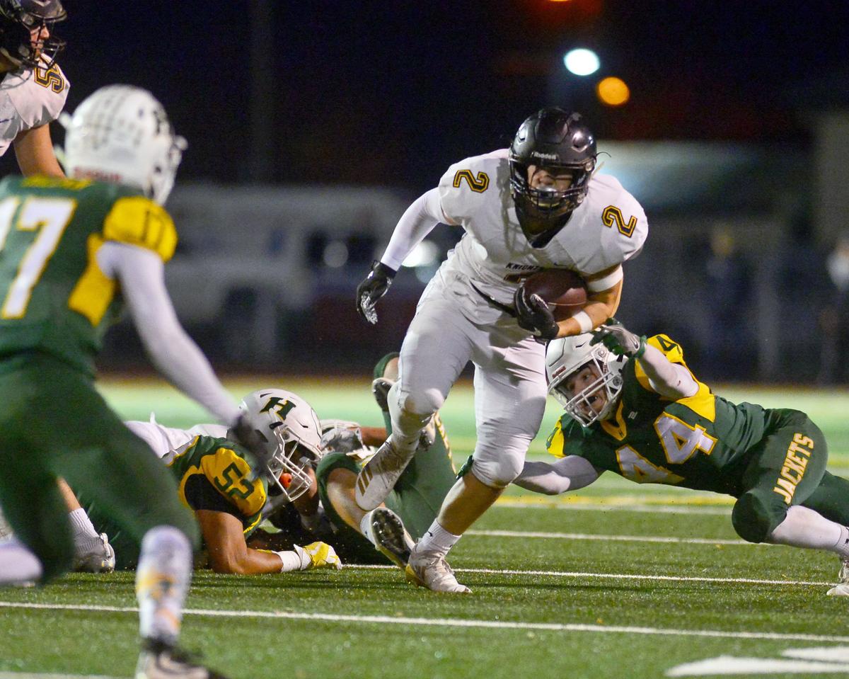 Ripon Christian running back Max Steele (2) runs past Hilmar defenders during the Division VI CIF Sac-Joaquin championship game between Ripon Christian and Hilmar at Turlock High School in Turlock CA on November 30, 2018.