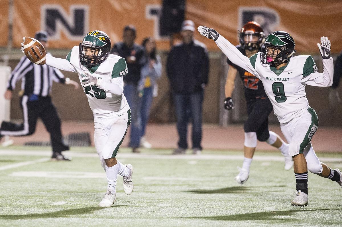 River Valley juniors Edson Leon (25) and Isaac Nava (9) celebrate after River Valley intercepted a Merced pass during a CIF Sac-Joaquin Section Division III playoff game at Veterans Stadium in Merced, Calif., on Friday, Nov. 9, 2018. The Falcons beat the Bears 45-40.