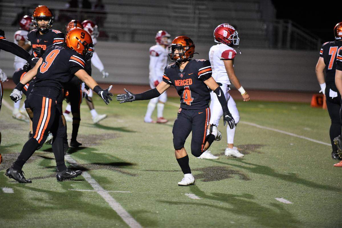 Merced High’s Gabe Lopez celebrates a touchdown catch with teammate Xavier Ortiz-Wilson during a game against Patterson on Friday, Oct. 18, 2019 at Veterans Stadium.