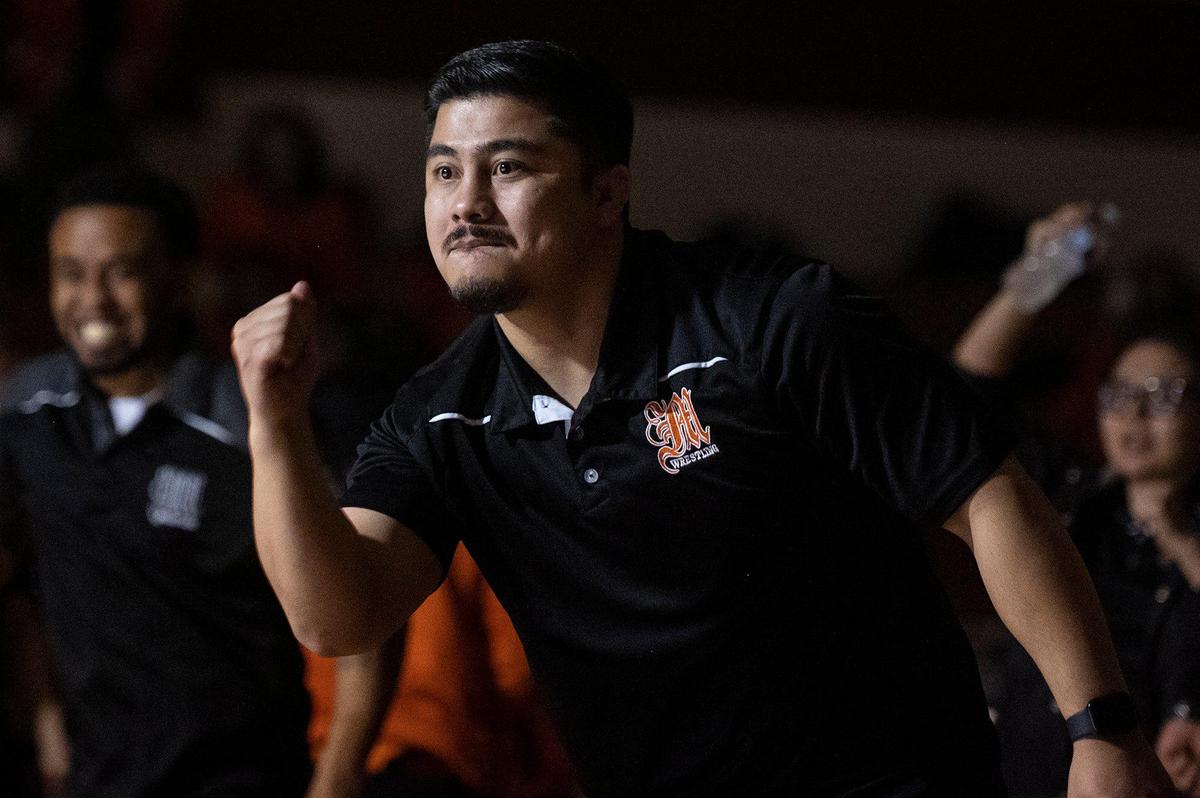The Merced bench cheers as Thomas Stanbrough defeats Golden Valley’s Michael Bennett by pin during a wrestling match at Golden Valley High School in Merced, Calif., on Tuesday, Jan. 23, 2024.