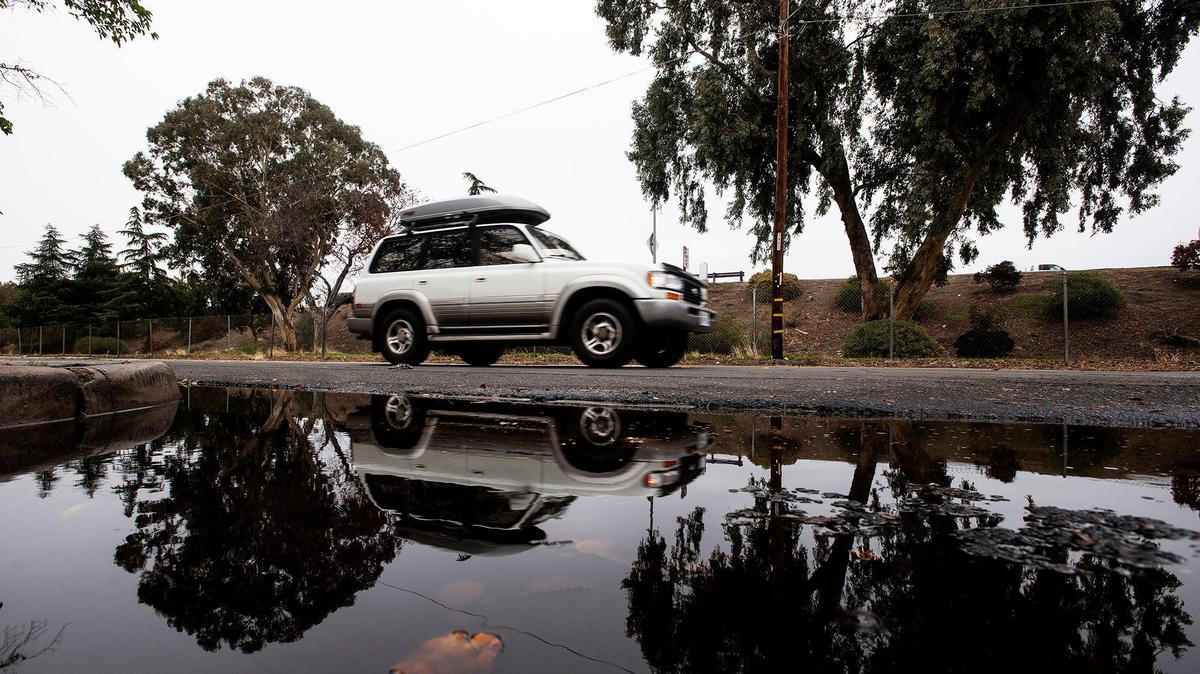 Motorists drive along West 13th Street near K Street in Merced, Calif., on Tuesday, Nov. 9, 2021.