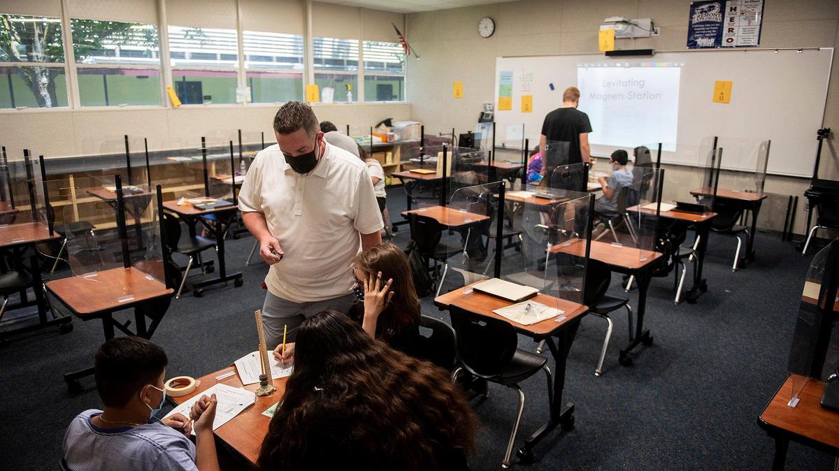 Teacher Preston Hansen instructs seventh grade students as they conduct science experiments using magnets during the Merced City School District Summer Academy at John C. Fremont Elementary School in Merced, Calif., on Wednesday, June 30, 2021. Hansen teaches math at Hoover Middle School.