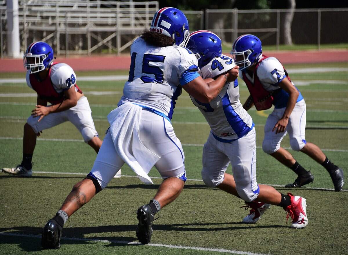 Senior tight end Xavier Williams blocks during a running play during practice at Atwater High on Wednesday, Aug. 21, 2019.