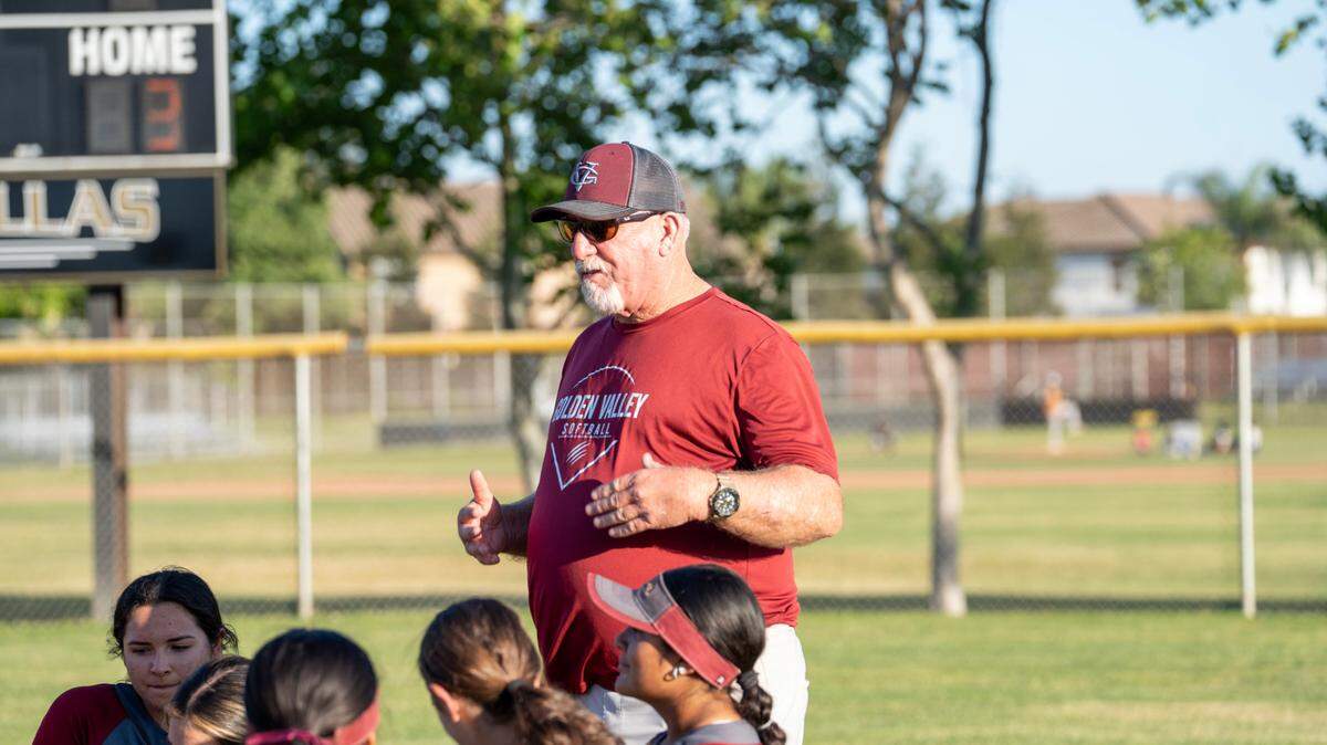 Head coach Ross Cruickshanks talking with players after a game on May 8.