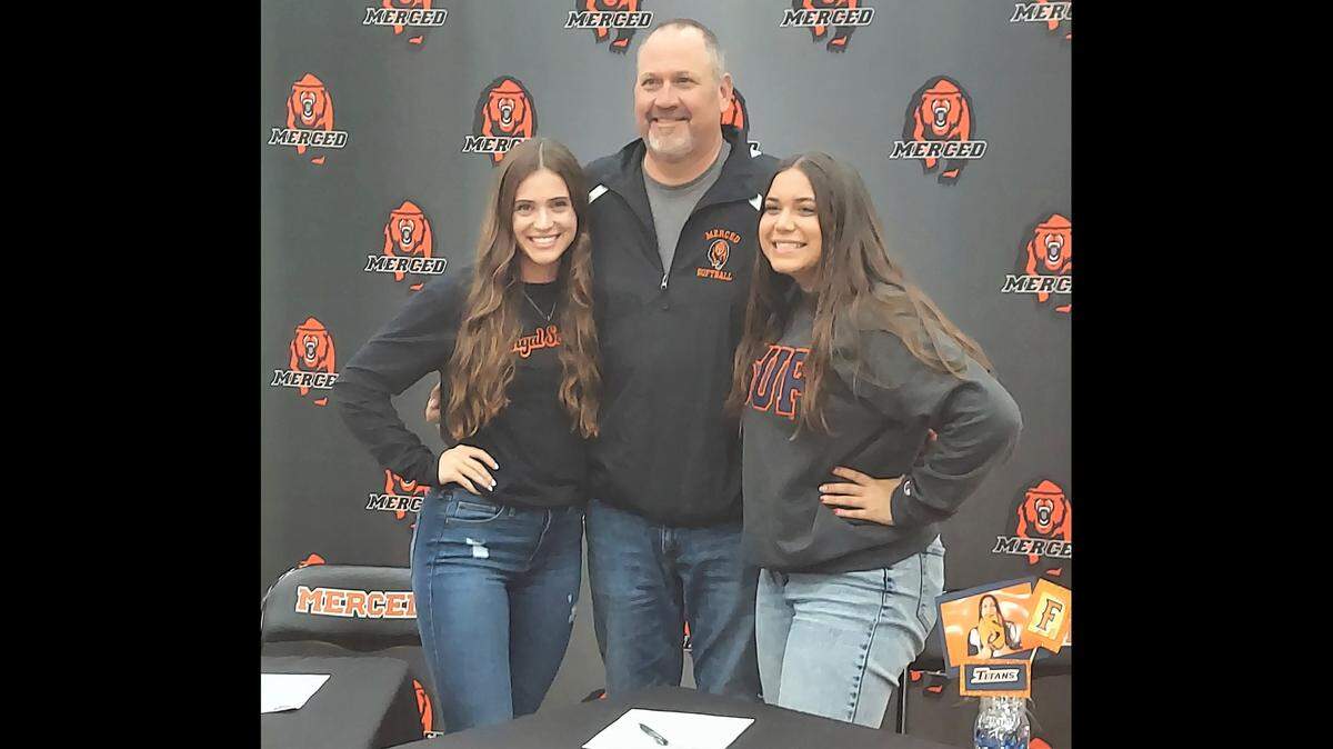 Merced High softball players Ava Brown (left) and Trisha McCleskey (right) pose for a photo with Bears softball coach John Kane during their signing ceremony at Merced High School on Wednesday, Nov. 10, 2021.