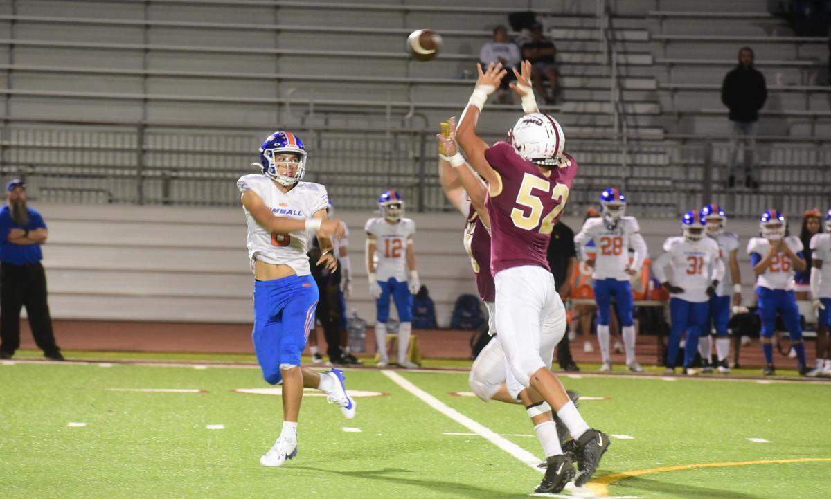 Golden Valley High defensive lineman Benito Lara (52) tips a pass from Kimball quarterback Richard Sandoval (8) during a game on Friday, Sept. 20, 2024 at Veterans Stadium in Merced, Calif.