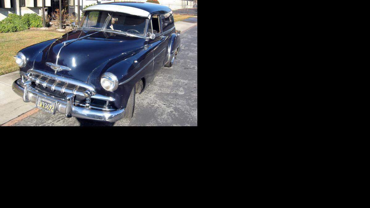  A set of vintage black license plates identify Alfred Lujan Garcia’s 1952 Chevrolet sedan delivery.
