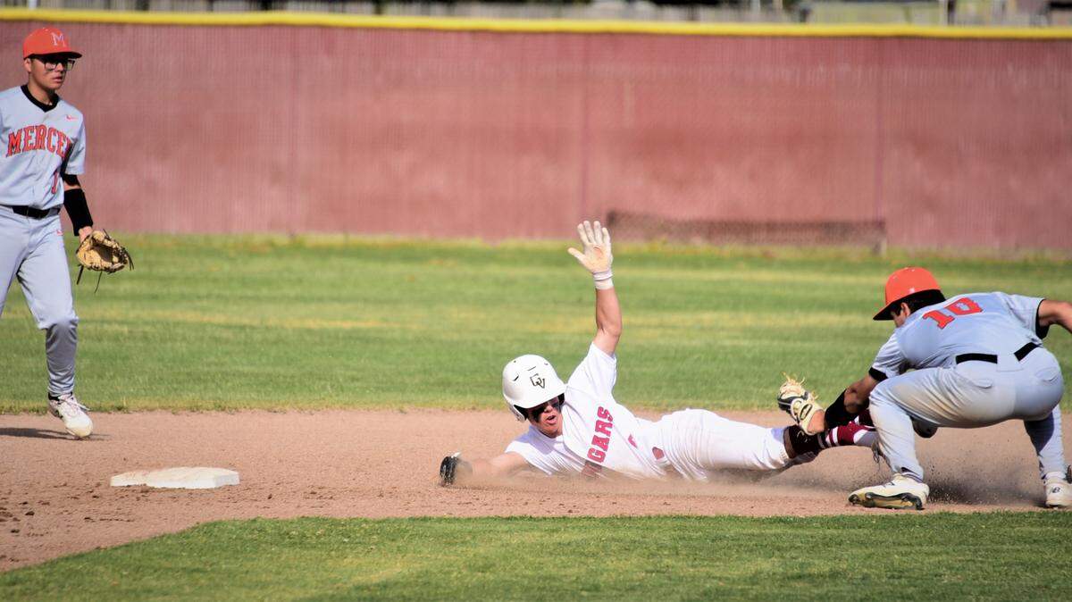 Golden Valley sophomore Koen Heupel triest to avoid the tag of Merced infielder Riley Dickey during a stolen base attempt at second base during a game on Wednesday, April 13, 2022 at Doug Fister Field at Golden Valley High School in Merced, Calif.