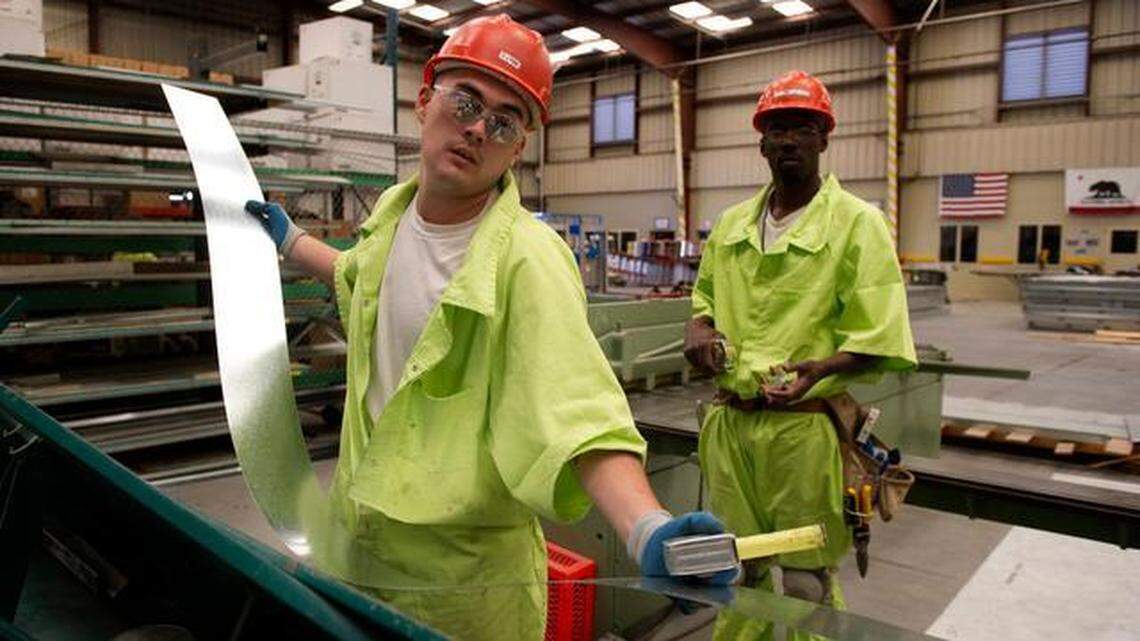 An inmate prepares a piece of sheet metal to build one of the components that will be used in a modular building built at the Prison Industry Authority compound at Folsom State Prison. 
