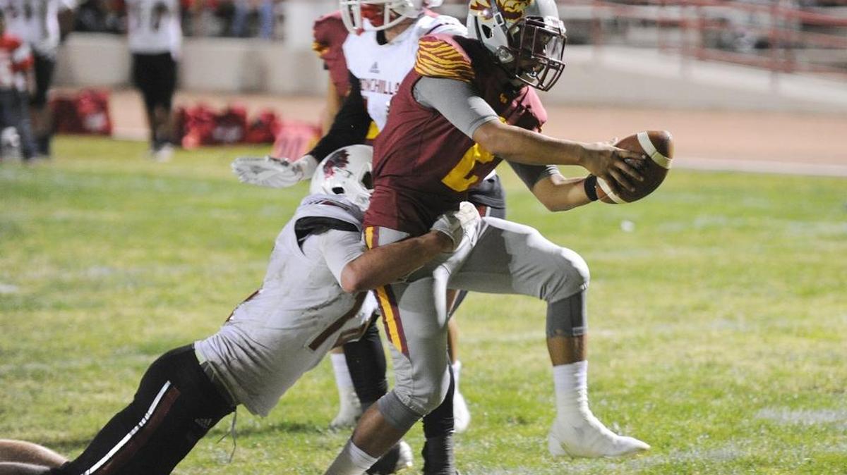 Los Banos quarterback Anthony Caballero scores a touchdown in the fourth quarter against Chowchilla High to make the score 28-0 at Loftin Stadium in Los Banos on Sept. 29, 2017.