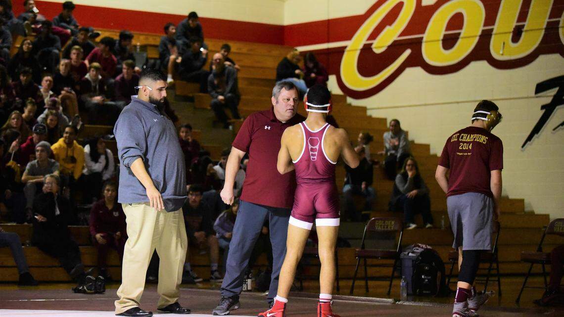 Golden Valley coach Chopper Mello talks with senior Willie Ward-Williams during a break in his match on Tuesday, Jan. 28, 2020 at Cougar Arena.