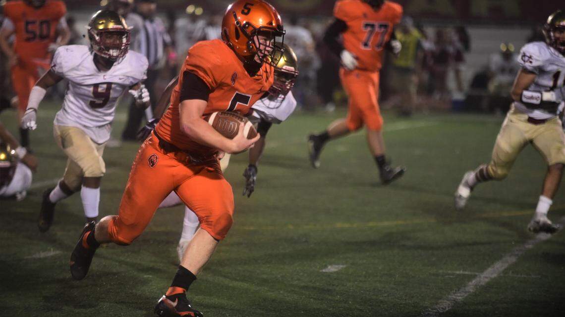 Merced High quarterback Seth Scheidt rushes for a 55-yard touchdown run against Golden Valley during a game on Friday, Oct. 29, 2021 at Veterans Stadium.