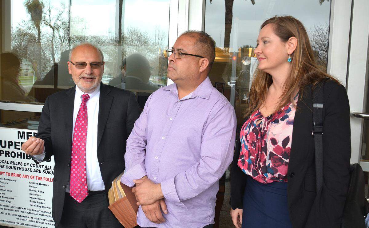 Joaquin Sotelo stands emotional between his attorneys Michael Mehr, left, and Eloise Kelsey, right, on Thursday, Feb. 14, 2019, in front of Merced Superior Court in Merced. Sotelo’s fight against deportation and path to citizenship became easier Thursday after a Merced County judge re-sentenced him on a 2014 felony conviction that led to mandatory deportation proceeidngs by ICE.