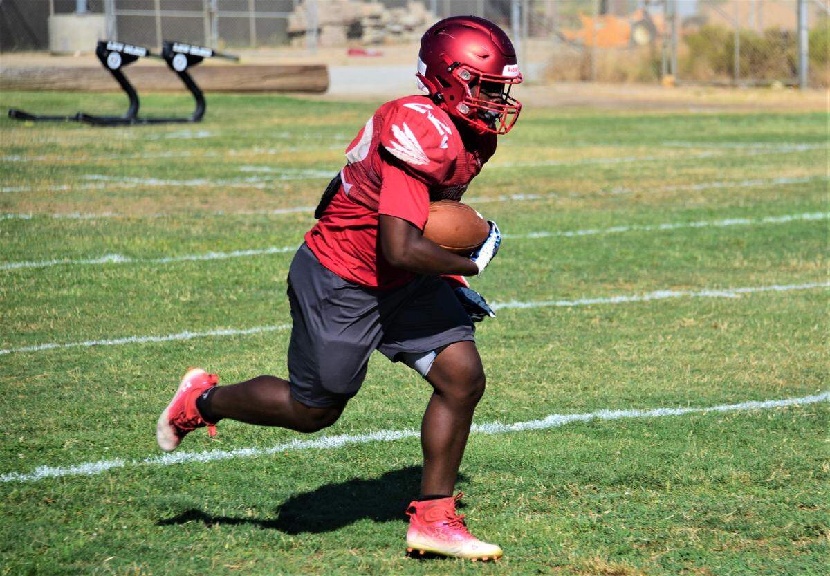 Chowchilla High School junior running back Dwayne Hemphill runs the ball during practice on Tuesday, Aug. 8, 2023.