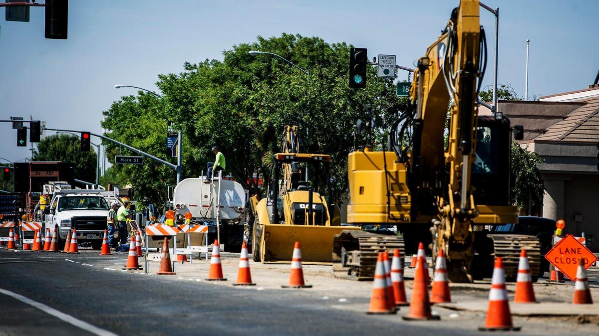 Road construction is performed on R Street at the intersection of R and 18th Street in Merced, Calif., Tuesday, May 26, 2015. Merced Sun-Star file image.