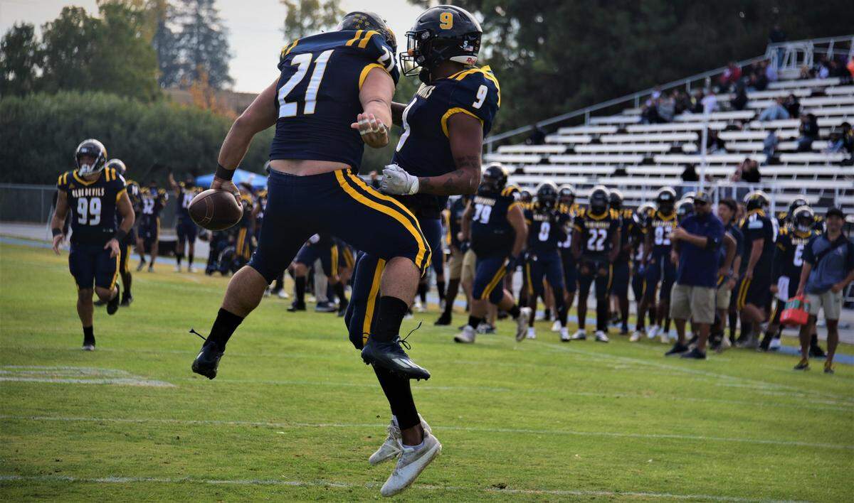 Merced College fullback Luke Anders (21) celebrates after scoring a touchdown with teammate Ronnie Harris (9) during a game against West Hills Coalinga on Saturday, Nov. 12, 2022 at Stadium ’76.