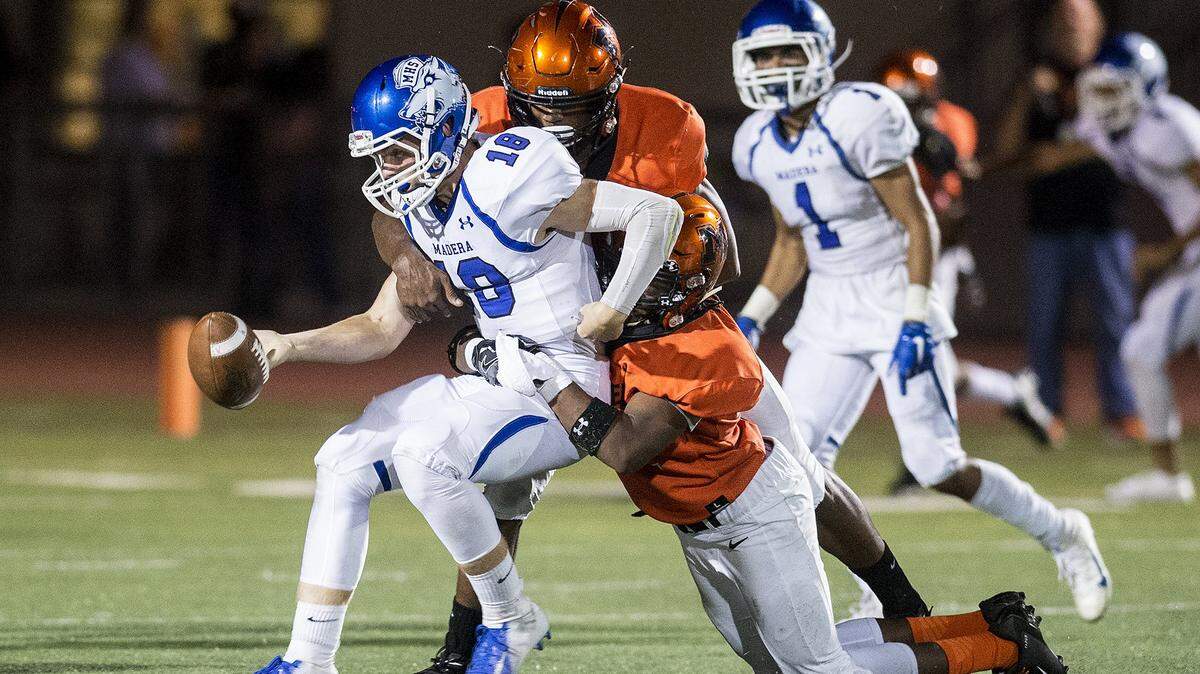 Madera senior quarterback Colt Nelson (18) fumbles the ball during a game against Merced at Veterans Stadium on the campus of Golden Valley High School in Merced, Calif., on Friday, Sept. 7, 2018. The Bears beat the Coyotes 63-35. 