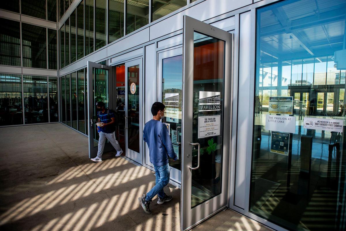 People enter and exit The Pavilion on the University of California, Merced campus in Merced, Calif., on Monday, March 14, 2022.