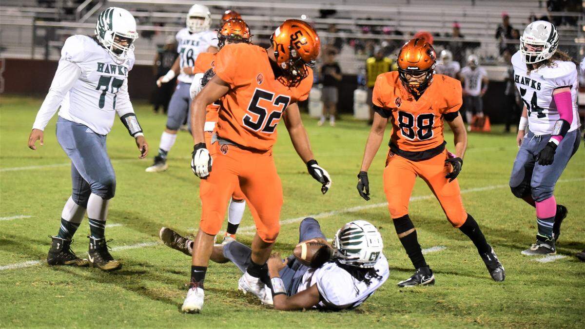 Merced High junior Jalonn Booth (52) reacts after recording one of his two sacks during a 56-14 win over Central Valley on Friday, Oct. 21, 2022 at Cathie Hostetler Stadium at Merced High School.