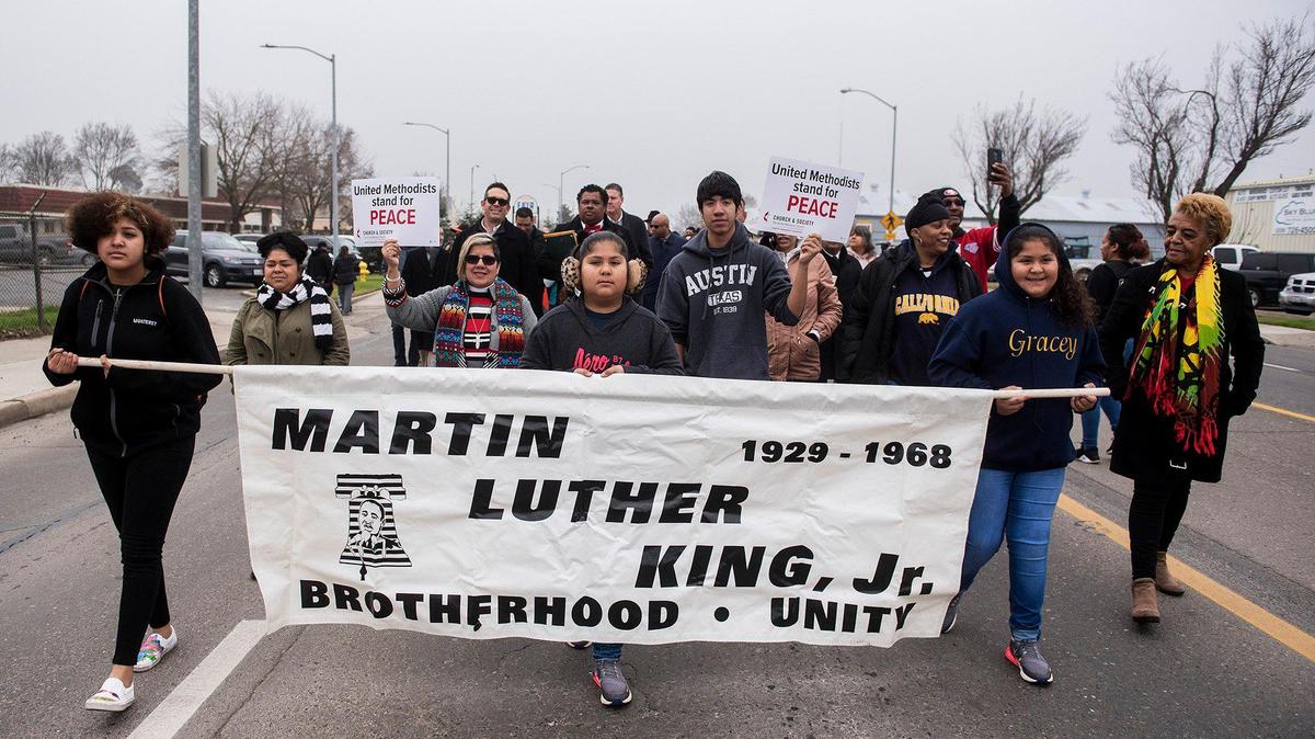 Members of the community walk along Martin Luther King Jr. Way during the annual Unity March to honor the legacy of the late civil rights trailblazer, Rev. Dr. Martin Luther King Jr., in Merced Calif., on Monday, Jan. 20, 2020.