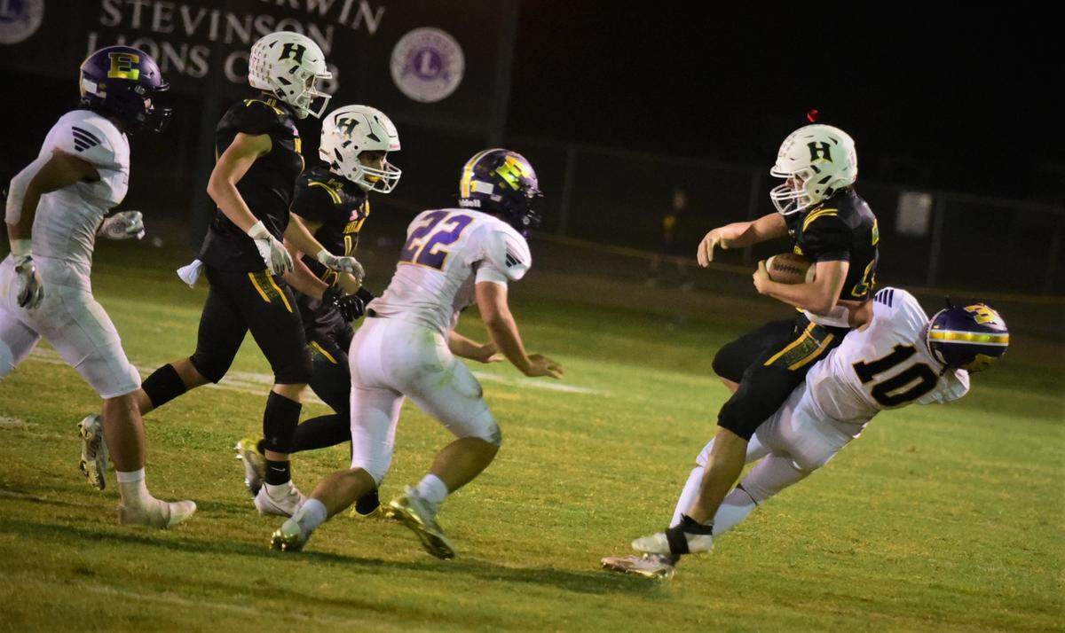 Escalon High’s Javier Gutierrez (10) tackles Hilmar quarterback Caden Bailey during a game on Friday, Sept. 30, 2022 in Hilmar, Calif.