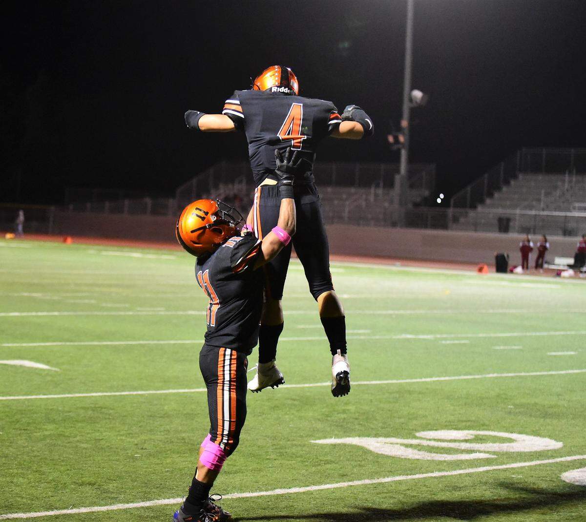 Merced High’s Desmond Thompson (left) and Gabe Lopez (4) celebrate Lopez’s touchdown catch in a game against Patterson on Friday, Oct. 18, 2019 at Veterans Stadium.