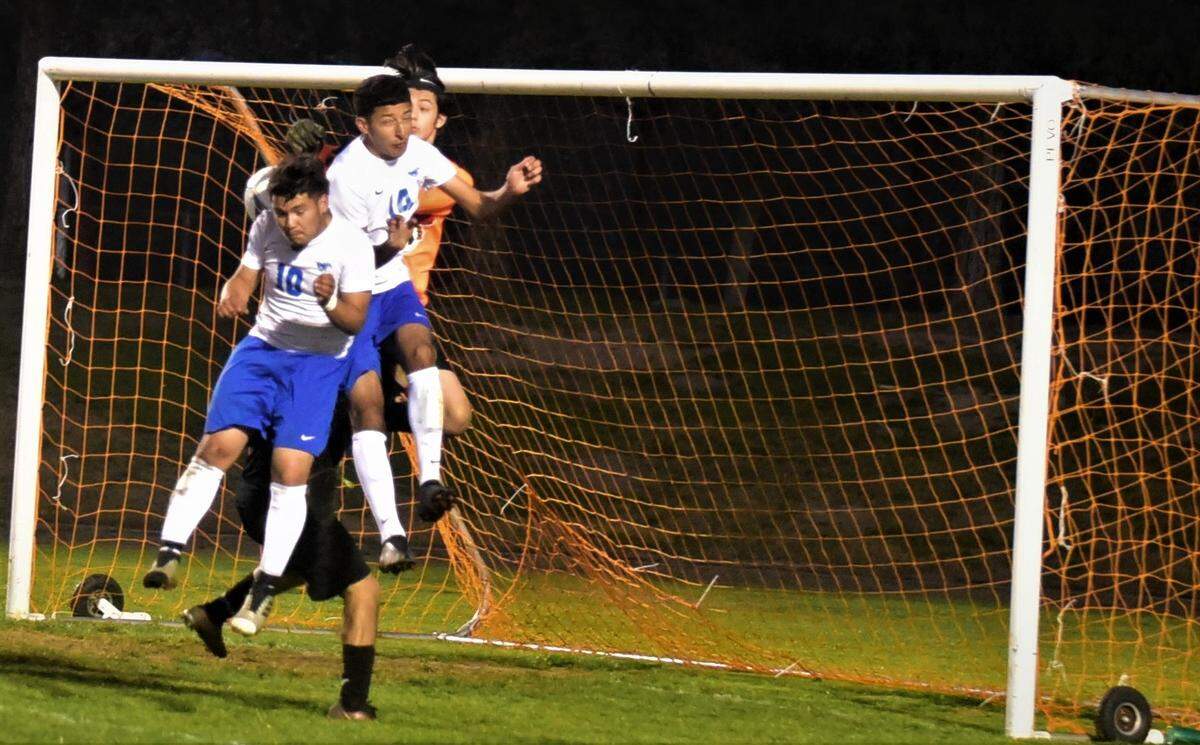 King City players Alejandro Ibarra (10) and Victor Narez (14) go up to head a corner kick in front of the Delhi net during a Northern California Regional Playoff match on Tuesday, March 1, 2022 at Delhi High School in Delhi, Calif.