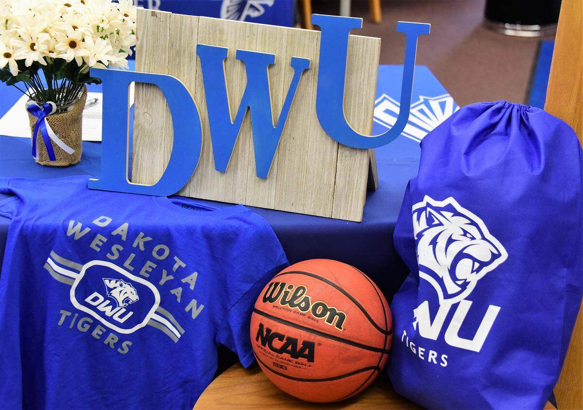 Atwater High twin sisters Kelsey and Lexi Valenica celebrating their signing with Dakota Wesleyan University on Tuesday, April 30, 2019 at thee Atwater High library.
