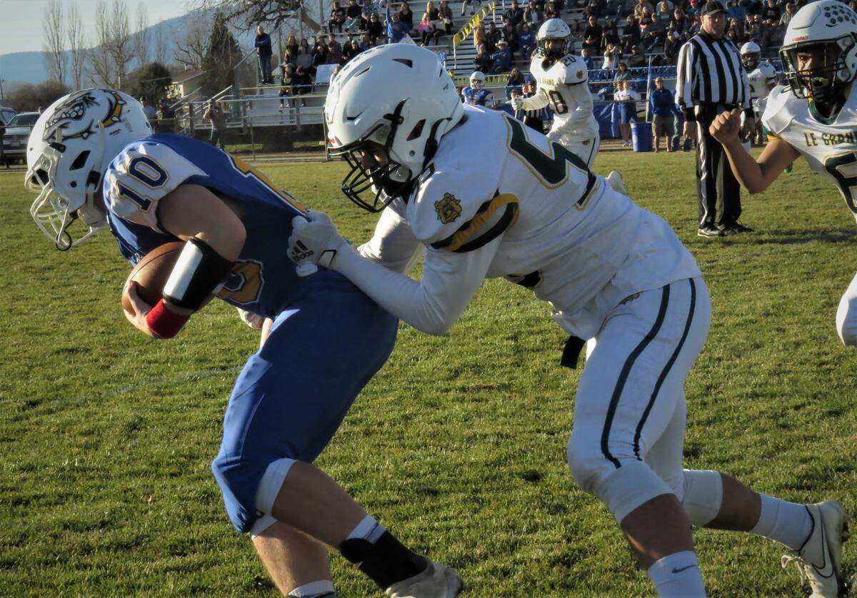 Le Grand High’s Raul Sanchez tackles Fall River’s Evan Bidwell (10) during the Northern California Regional Division VII-AA Championship in McArthur, Calif. on Saturday, Dec. 4, 2021.