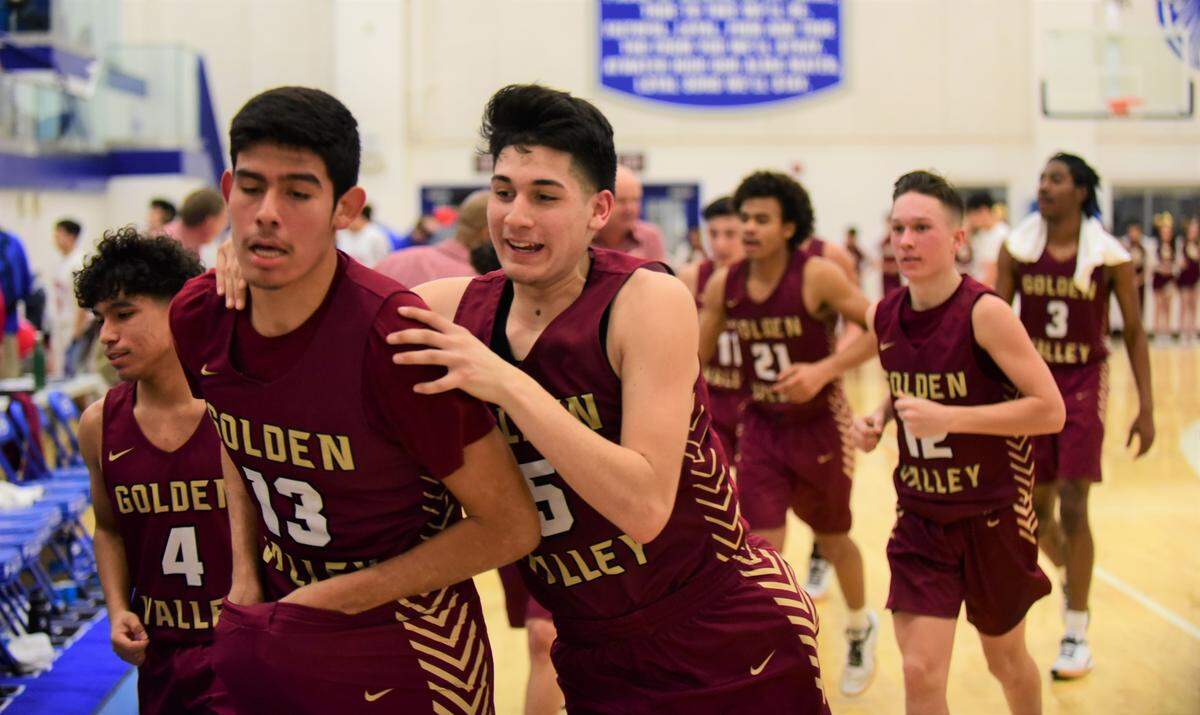 Golden Valley’s Christian Magallanes (5) and Anthony Mendez (13) lead the Cougars off the court at halftime during a game against Atwater High on Wednesday, Jan. 22, 2020.