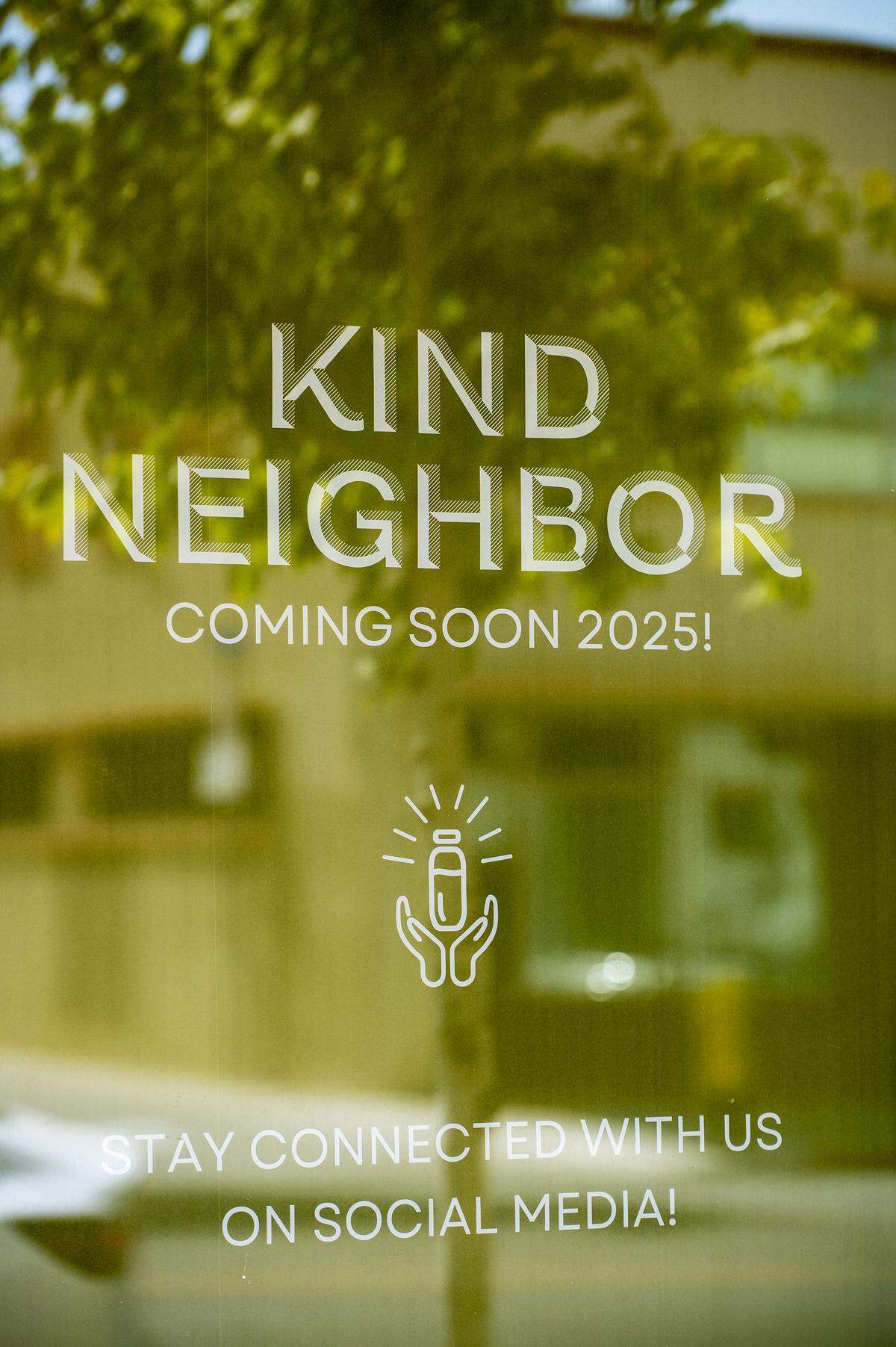Signage for Kind Neighbor, a Merced juice bar, is seen in the windows at 1717 M Street in Merced, Calif., on Monday, Aug. 25, 2025. The juice bar will be reopening in the new location in September. 
