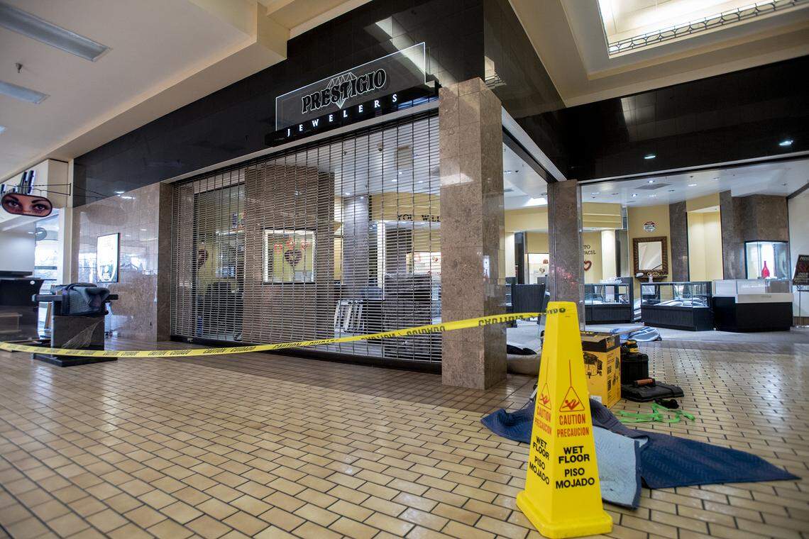 Work is performed inside Prestigio Jewelers at the Merced Mall in Merced, Calif., on Thursday, Feb. 10, 2022, as the business prepares to reopen after thieves stole more than $100,000 in merchandise during a smash-and-grab robbery two days earlier.