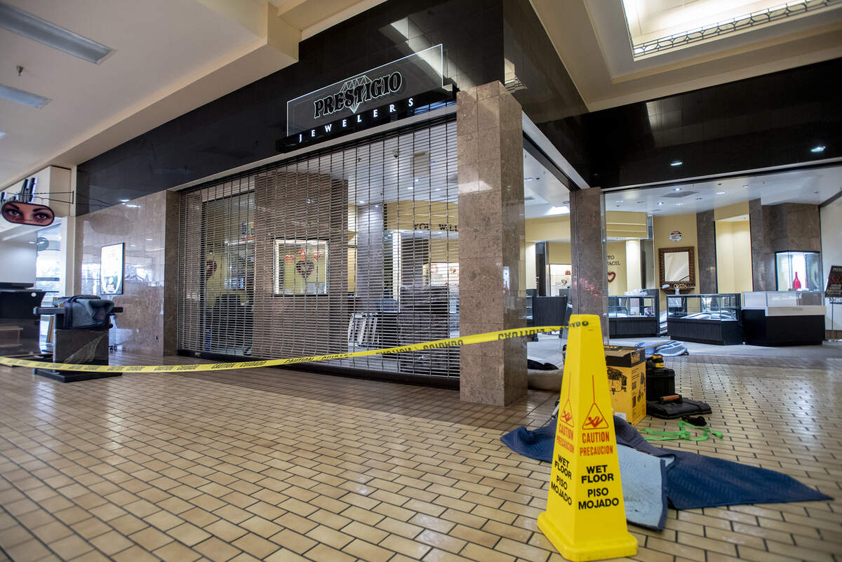 Work is performed inside Prestigio Jewelers at the Merced Mall in Merced, Calif., on Thursday, Feb. 10, 2022, as the business prepares to reopen after thieves stole more than $100,000 in merchandise during a smash-and-grab robbery two days earlier.