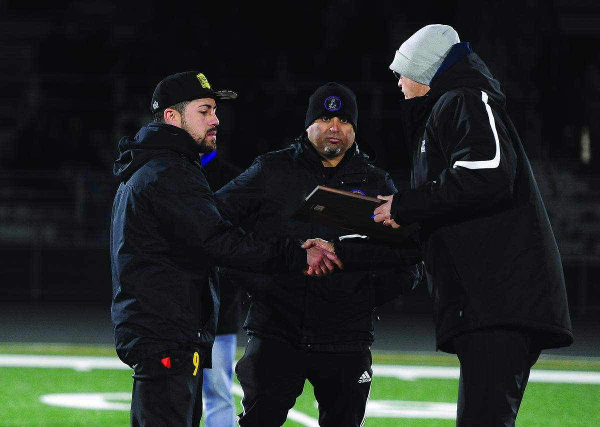 BEA AHBECK/NEWS-SENTINEL Livingston coaches Art Pulido and Jesse Vega receive their second place plaque during their CIF Sac-Joaquin Section Boys Division IV Soccer Championship game Thursday, Feb. 21, 2019.