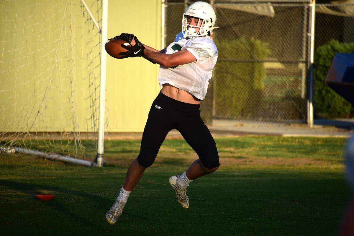 Hilmar High receiver John Labno hauls in a pass during practice on Tuesday, Aug. 6, 2024.