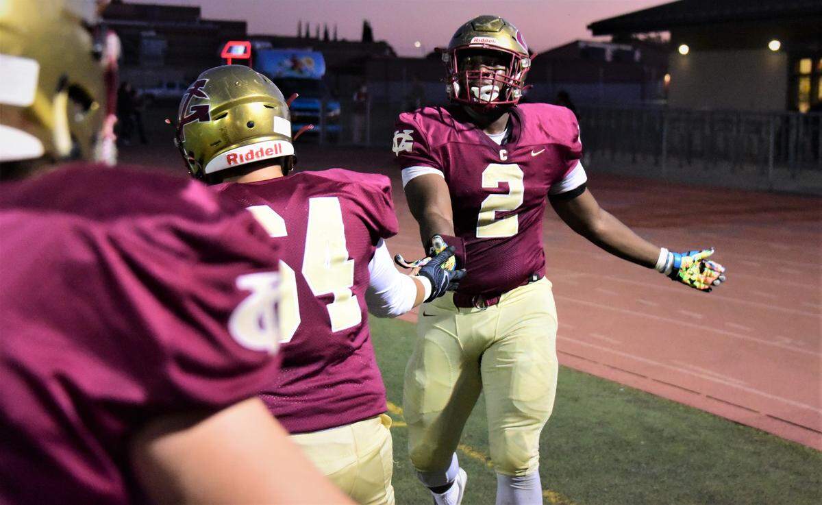 Golden Valley senior Jamarcus Phillips celebrates with teammates after scoring a touchdown on a fumble recovery during a game against Central Valley on Wednesday, Sept. 29, 2021 at Veterans Stadium in Merced, Calif.
