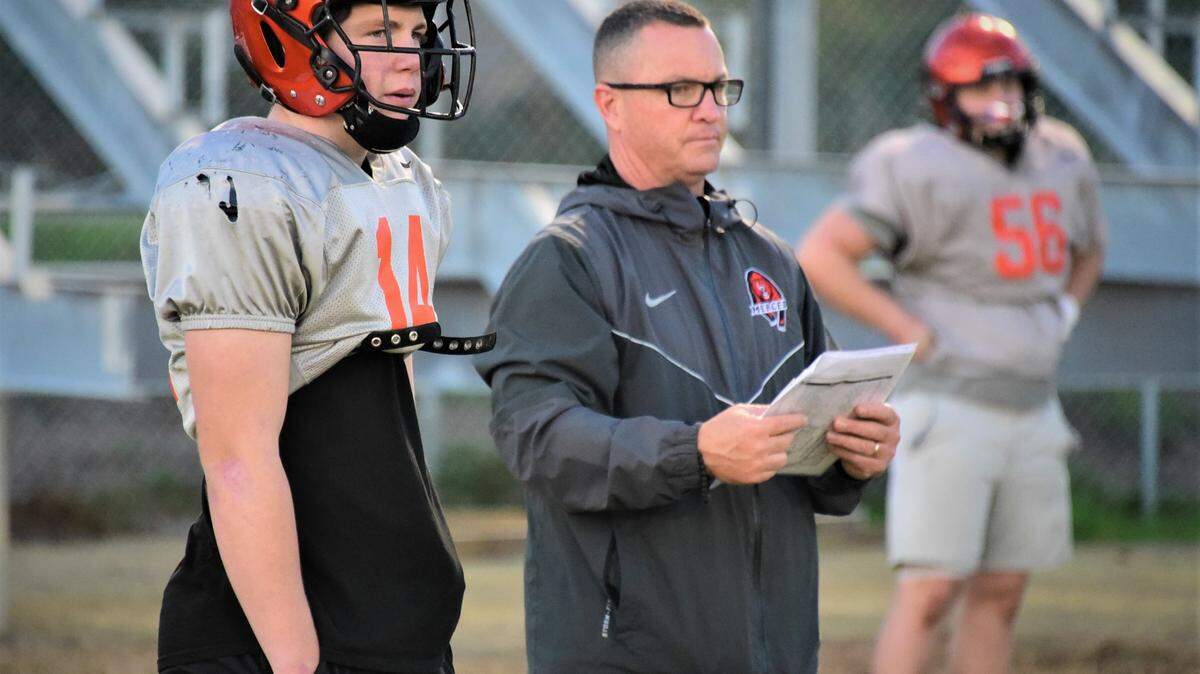 Merced High head coach Rob Scheidt (right) and his son, quarterback Seth Scheidt (left) look on during practice on Tuesday, Nov. 23, 2021 at Merced High School.