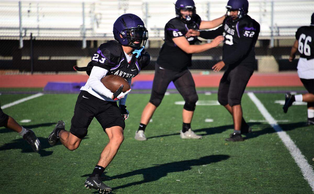 Pacheco High School senior Abraham Fernandez carries the ball on a sweep during practice on Wednesday, Aug. 2, 2023 at Pacheco High School in Los Banos, Calif.