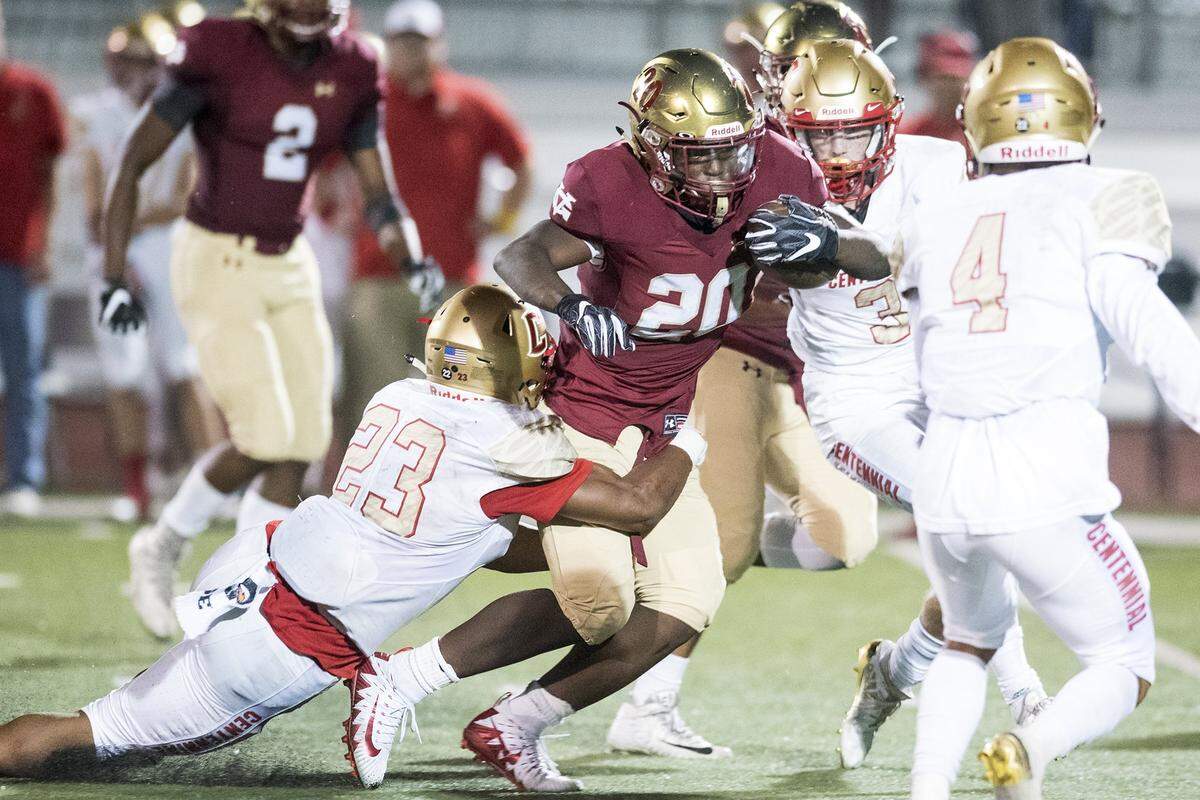 Golden Valley senior Jaren Phillips (20) attempts to break a tackle during a game against Centennial at Veterans Stadium on the campus of Golden Valley High School in Merced, Calif., on Friday, Aug. 31, 2018. The Golden Hawks beat the Cougars 38-15.