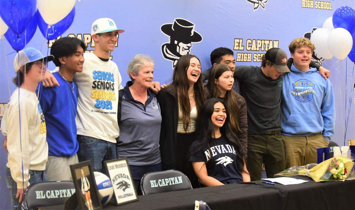 El Capitan High School senior Leah Mendoza takes photos with friends after signing her national letter of intent to play volleyball at the University of Nevada-Reno on Thursday at El Capitan High School in Merced, Calif.