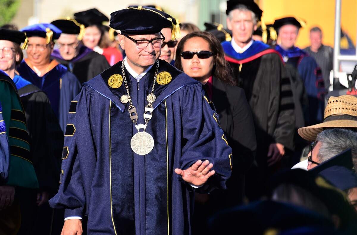 UC Merced Chancellor Dr. Juan Sánchez Muñoz makes his way to the stage during UC Merced’s commencement ceremony on Friday, May 12, 2023.