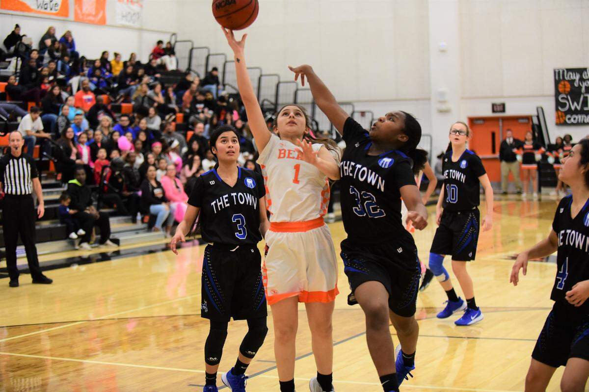 Merced High’s Sarah Rivas (1) goes up for a shot against Atwater’s Amoni Claiborne (32) during a game on Thursday, Feb. 6, 2020.