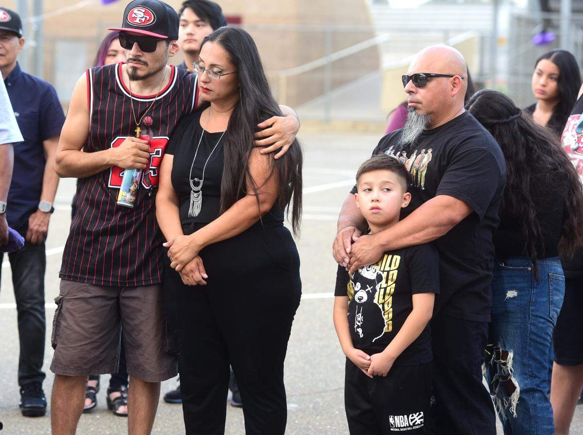 The family of Oscar Xavier Rodriguez look on during a candlelight vigil held at Golden Valley High School in Merced, Calif. on Friday, Aug. 3, 2024. Rodriguez, 15, was struck and killed by a vehicle while riding his bike home on July 25, 2024.