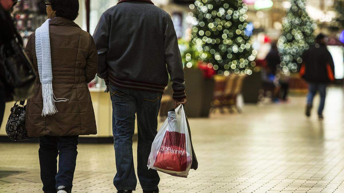Shoppers are shown carry multiple bags of items while walking through the Merced Mall on Black Friday in 2015. This year, retailers are hoping shopping will return to pre-pandemic levels.