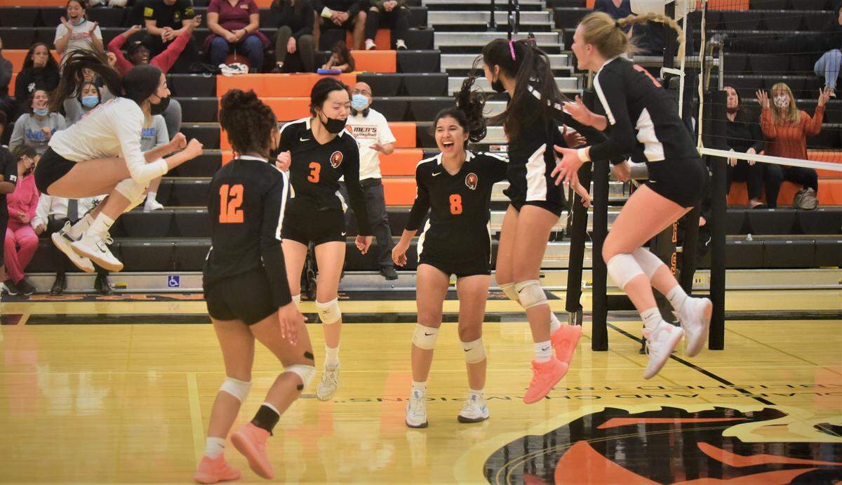 The Merced High volleyball team celebrates the final point in game four against Buhach Colony during a match at Merced High School on Tuesday, Oct. 19, 2021.