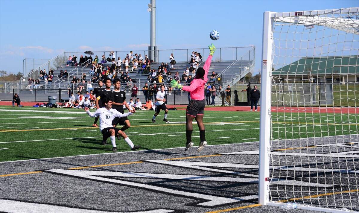 Le Grand High junior Hector Tejada gets off a shot that sails high as Encina goalie David Perry leaps for the ball during the Sac-Joaquin Section Division VI championship game at Liberty Ranch High School on Satura, Feb. 22, 2020 in Galt, Calif.