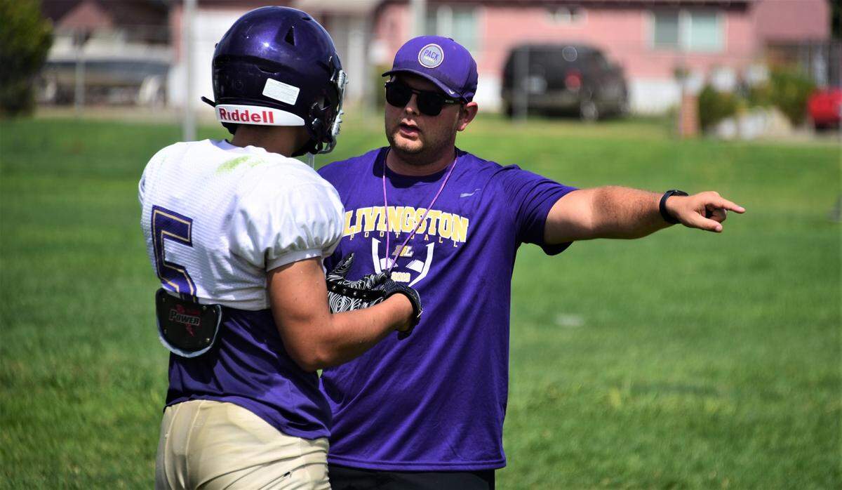 Livingston High School’s first-year head coach Steven Wine talks with senior Carlos Baez during practice on Tuesday, Aug. 2, 2022 at Livingston High School.