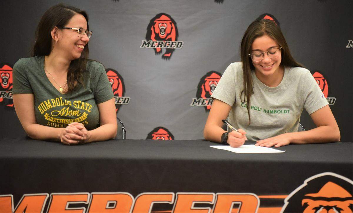 Merced High senior Isabel Perez-Zoghbi signs her national letter of intent to accept a track & field scholarship to Cal Poly Humbold during a ceremony on Tuesday, May 24, 2022 at the Merced High gymnasium.