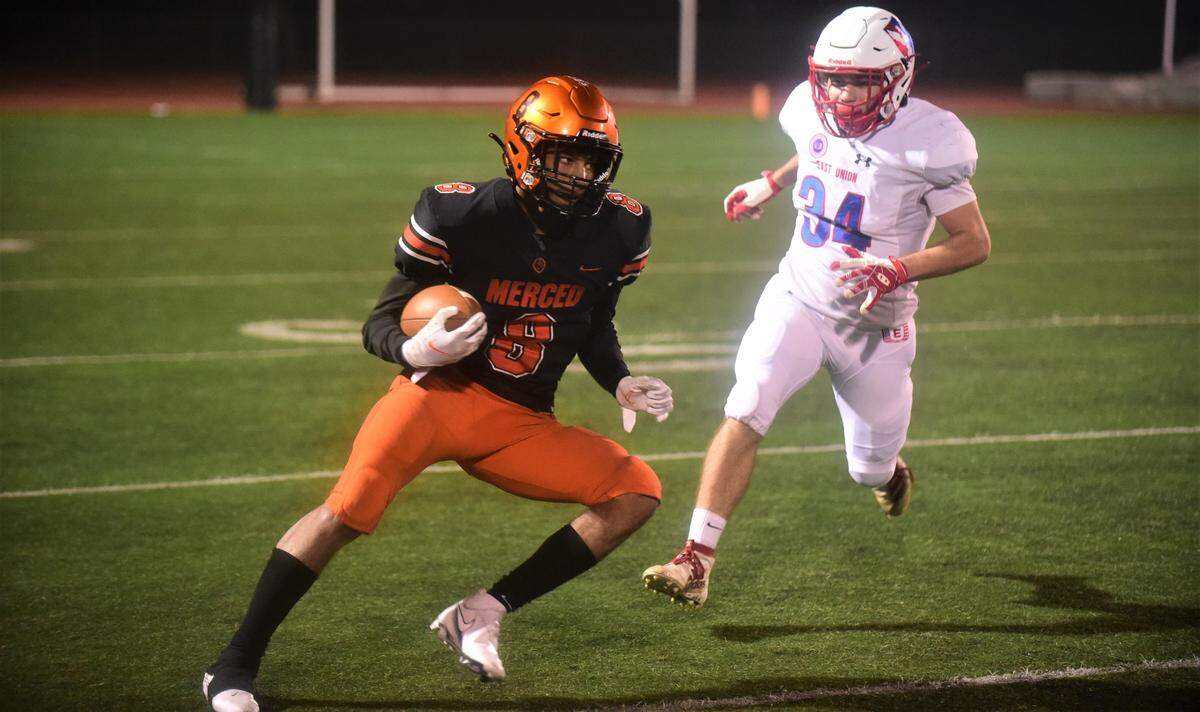 Merced High receiver Enoch Evans (8) runs up field as East Union’s Payton Graham gives chase during the Bears’ 56-15 win in the second round of the Sac-Joaquin Section Division IV playoffs on Friday, Nov. 12. 2021 at Veterans Stadium in Merced, Calif.